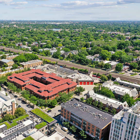 a bird's eye view of a city with a large red building in the center.