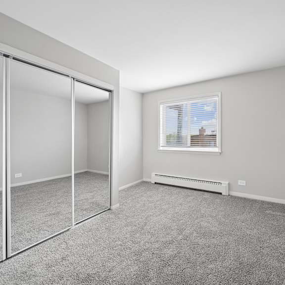 a room with a window and a radiator on the wall.
