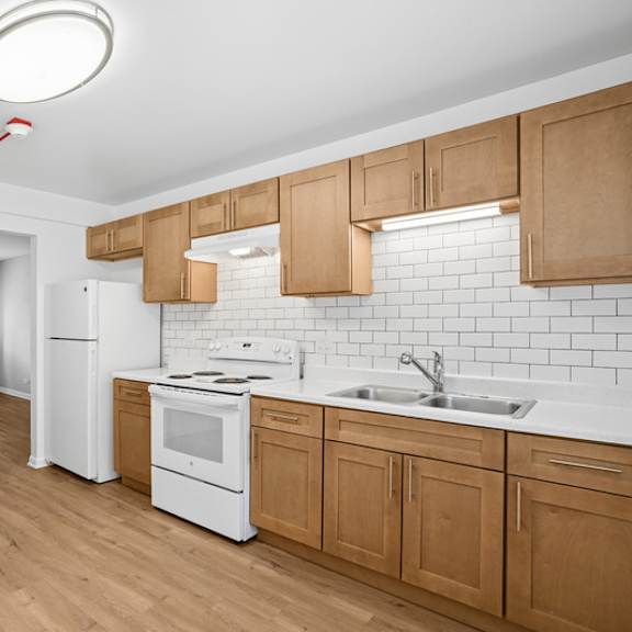 a kitchen with wooden cabinets and white appliances.