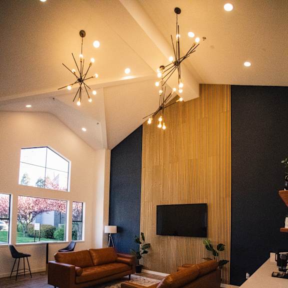 a large living room with couches and a television