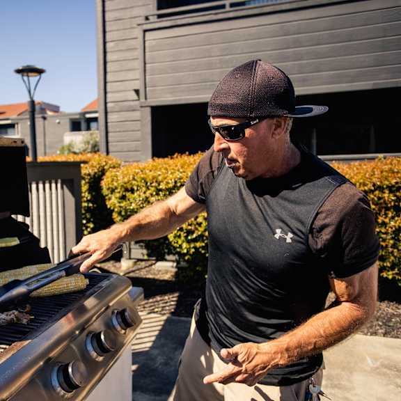 a man grilling food on a barbecue grill