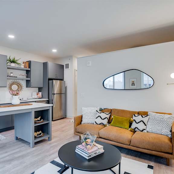a modern kitchen with a dining table and a couch at sora apartments, minneapolis, mn