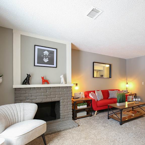 a living room with a couch and a fireplace