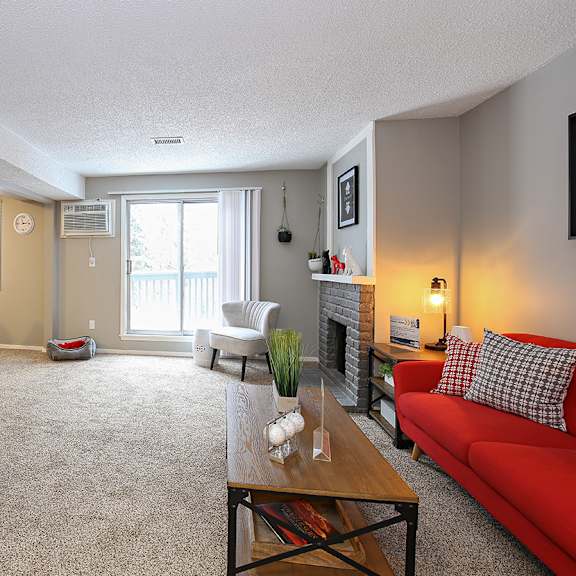 a living room with a red couch and a table