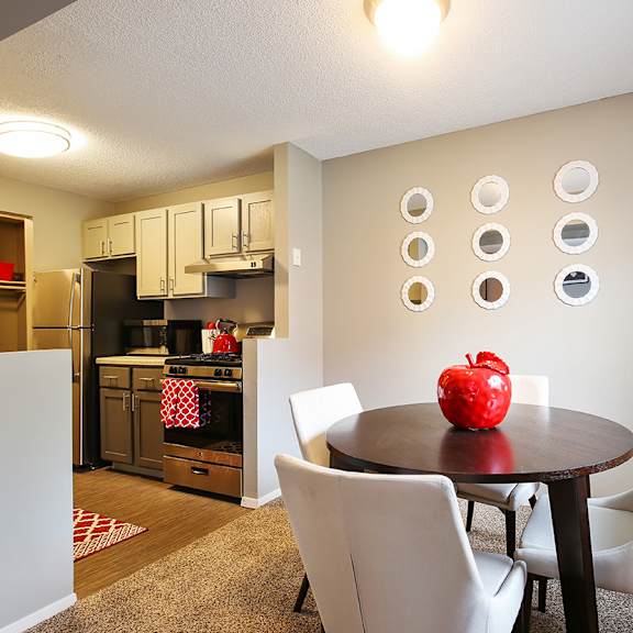 a dining room with a table and chairs and a kitchen