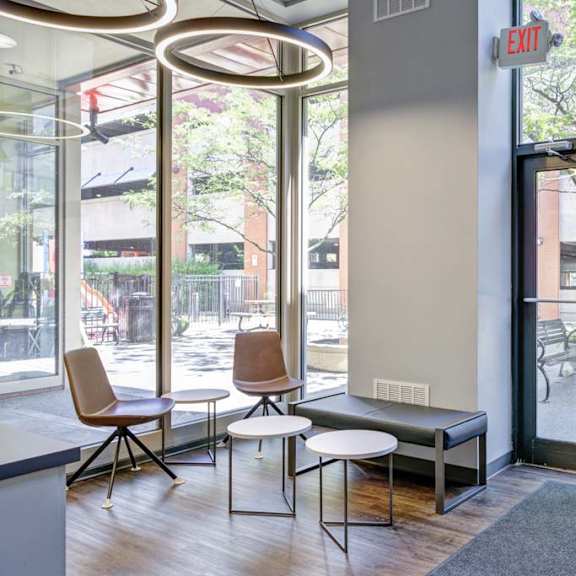 a room with a bench and chairs in front of a window at flats at southside, pittsburgh, 15203