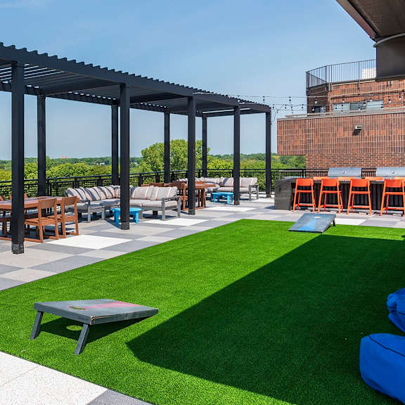 patio with black metal pergola at the venue on knox apartments, minnesota