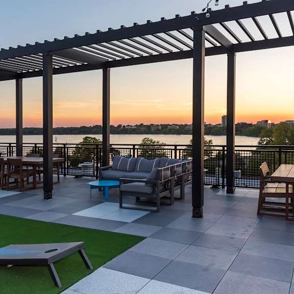 patio with table and chairs under a pergola at the venue on knox apartments, minneapolis, mn