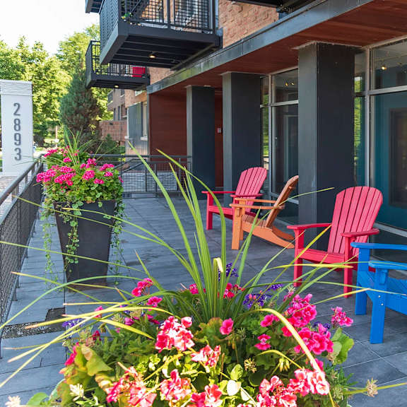 patio with red and blue chair at the venue on knox apartments, minneapolis, 55408