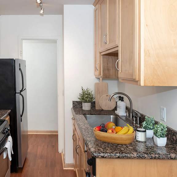 kitchen with cabinets at the venue on knox apartments, minnesota, 55408