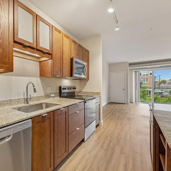 a kitchen with wooden cabinets and a granite countertop.
