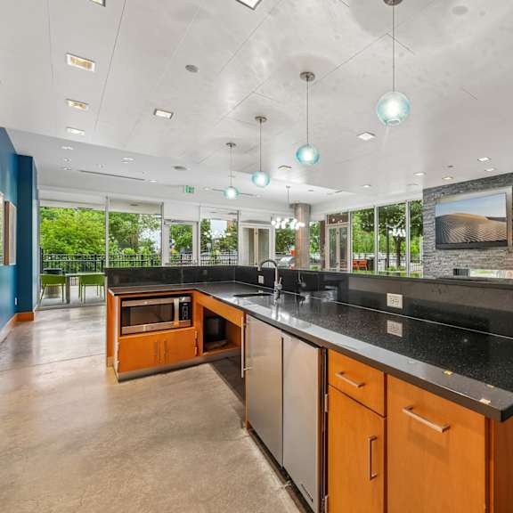 a kitchen with a black counter top and wooden cabinets.