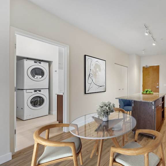 a modern kitchen with a glass table and chairs.
