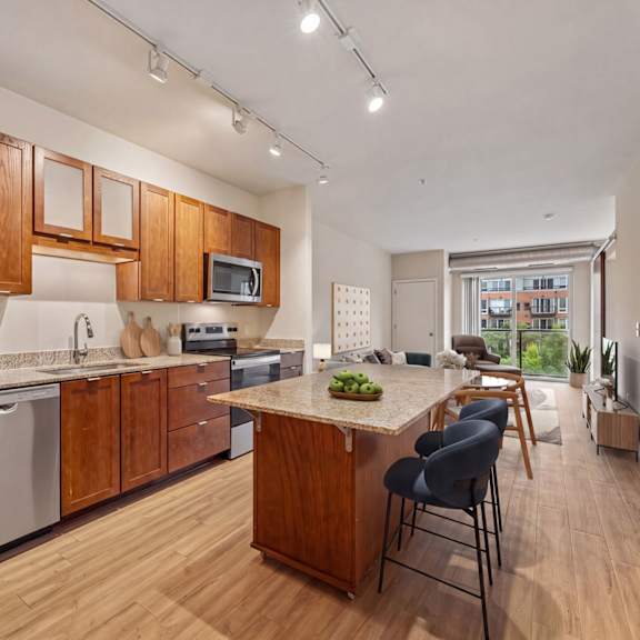 a kitchen with wooden cabinets and a stainless steel refrigerator.