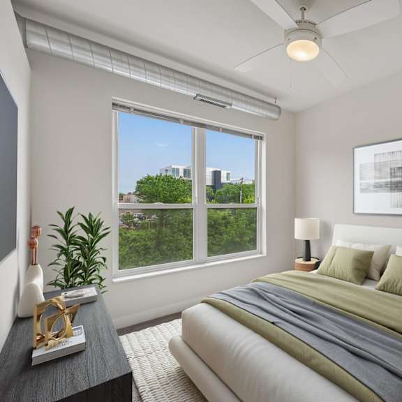 a bedroom with a large bed and a ceiling fan.