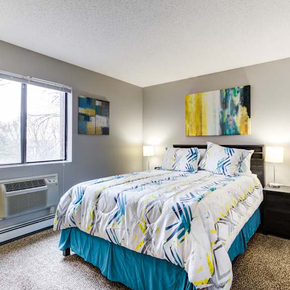 a bedroom with a bed and a window