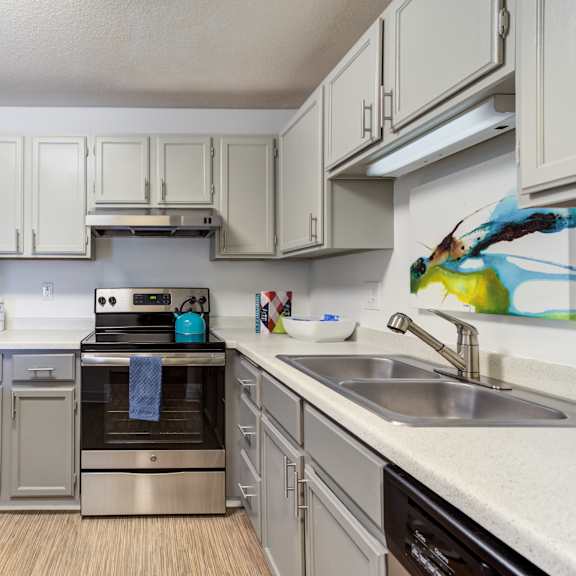 a kitchen with white cabinets and stainless steel appliances