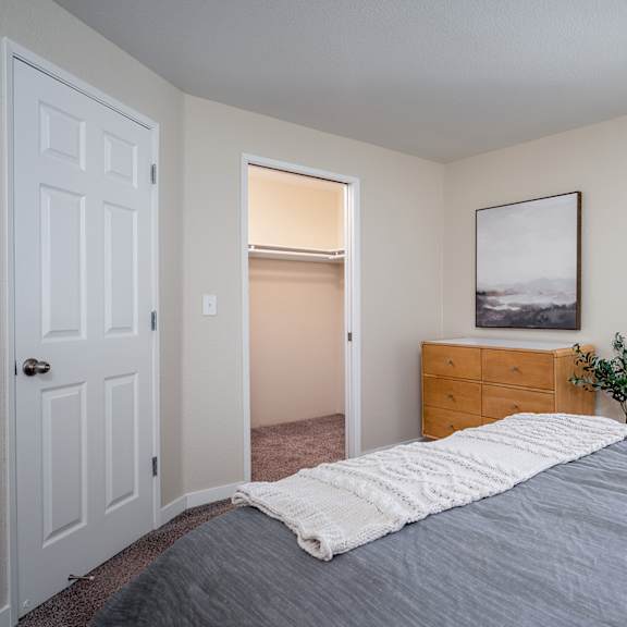 an empty bedroom with a bed and a closet at sundial apartments, oregon, 97070
