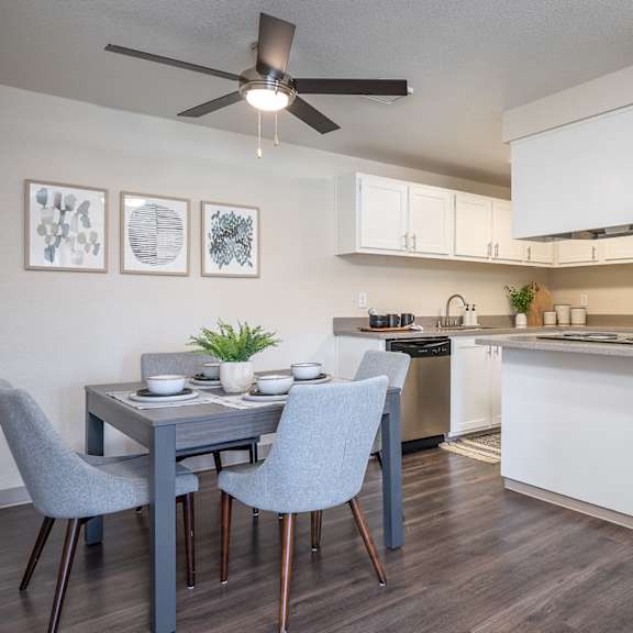 an open kitchen and dining room with a blue table and chairs at sundial apartments, wilsonville oregon
