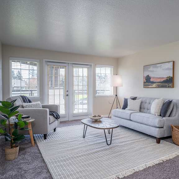 a living room with a couch and a chair and a window at sundial apartments, wilsonville, 97070