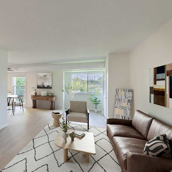 a modern living room with a brown leather couch and a white kitchen area.