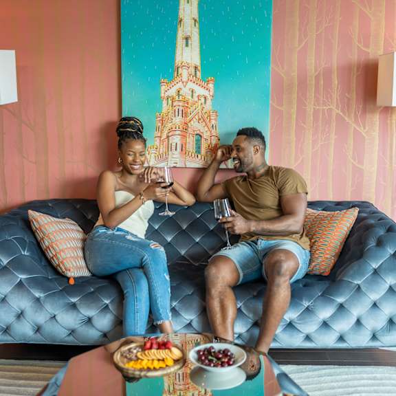 a couple sitting on a couch drinking wine  at west77 apartments, illinois, 60654