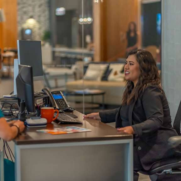 a woman sitting at a desk with a computer in front of her  at west77, chicago, il, 60654