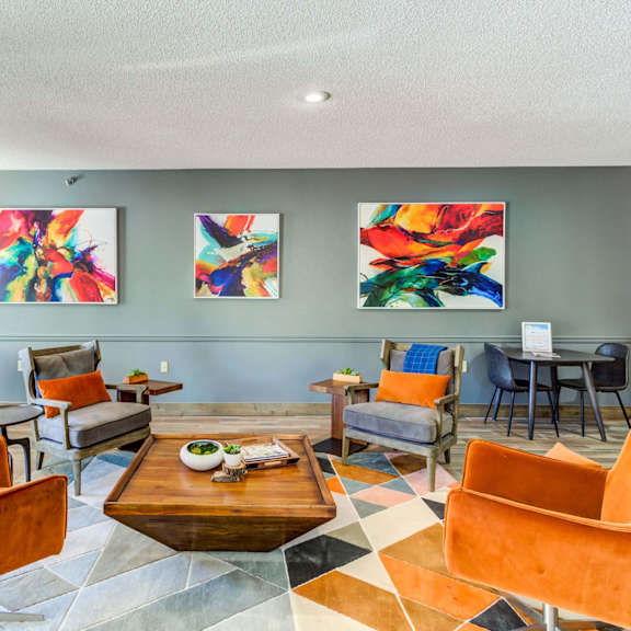 a living room with orange chairs and a coffee table on a checkered floor