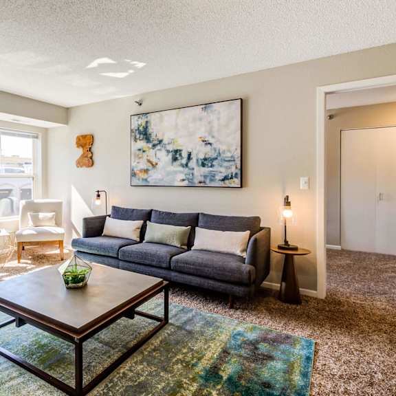 a living room with a large window and a couch