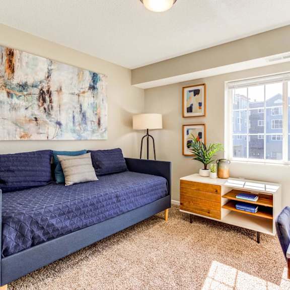 a living room with a couch and a desk