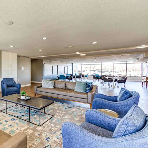 a living room filled with furniture and a large window