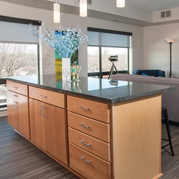 kitchen with wooden cabinets and black countertop at zest, minnesota, 55419