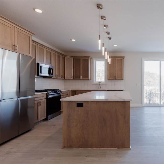 a kitchen with wooden cabinets and a central island.