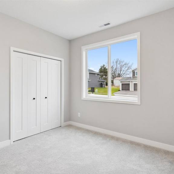 a room with a large window and two doors.