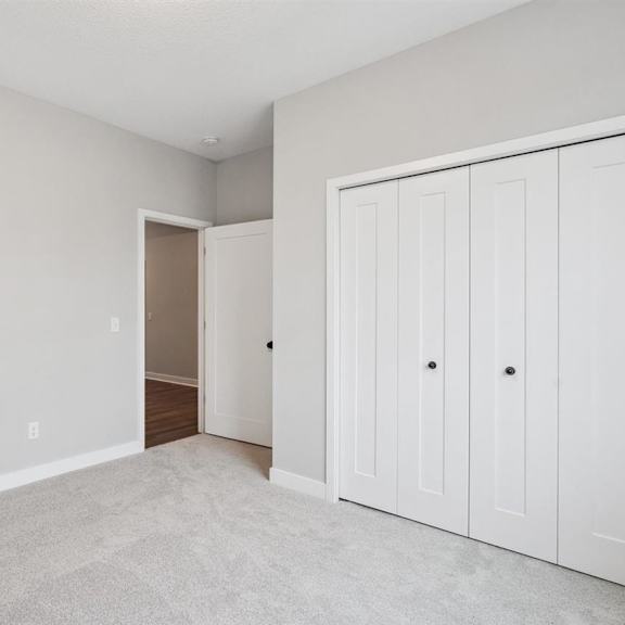a room with a white door and a white cabinet.