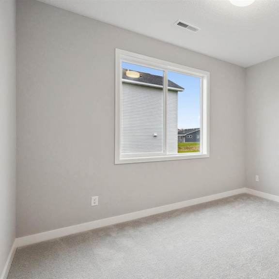 a room with a window and a view of a building outside.