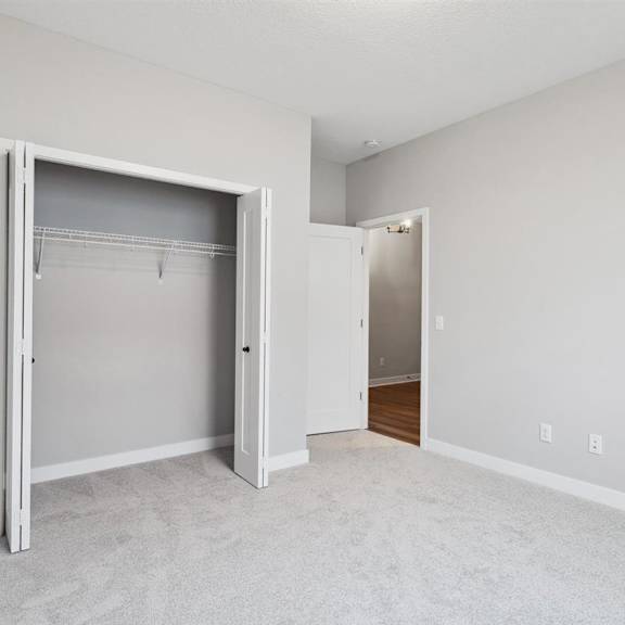 a white room with a large open closet door.