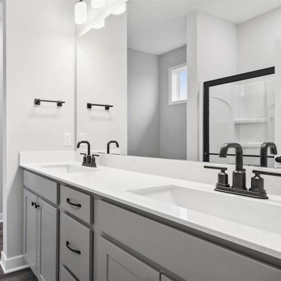 a bathroom with a white sink and a white door.