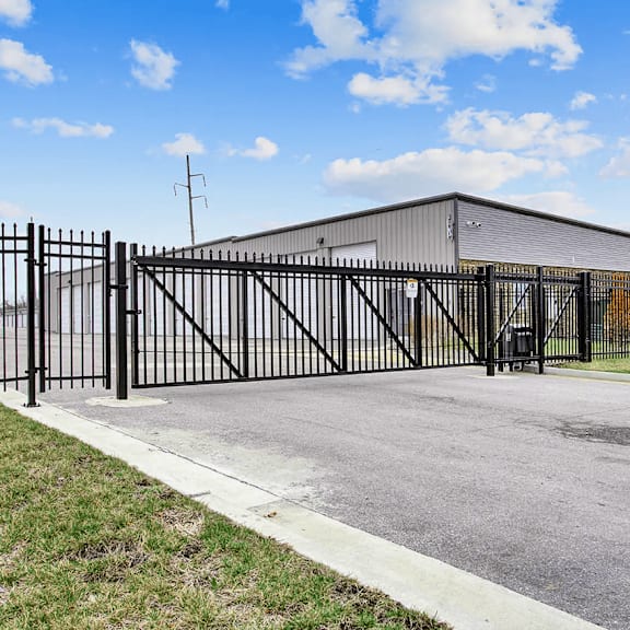 a black metal gate blocks the entrance to a building.