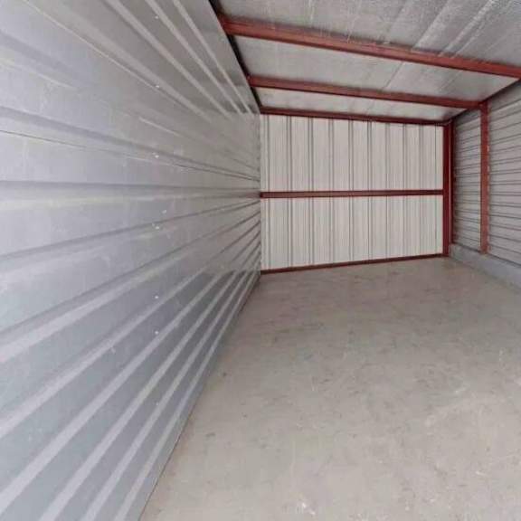 a storage unit with grey walls and red trim.