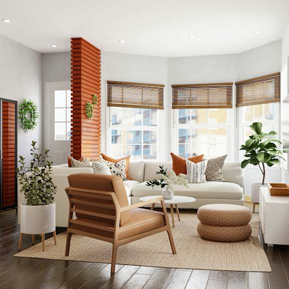 a living room with a white couch, a brown chair, and a white coffee table.