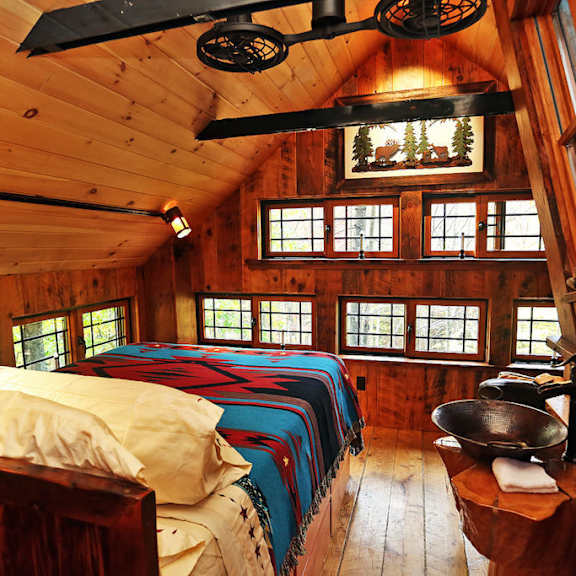 a bedroom with two beds in a wooden cabin