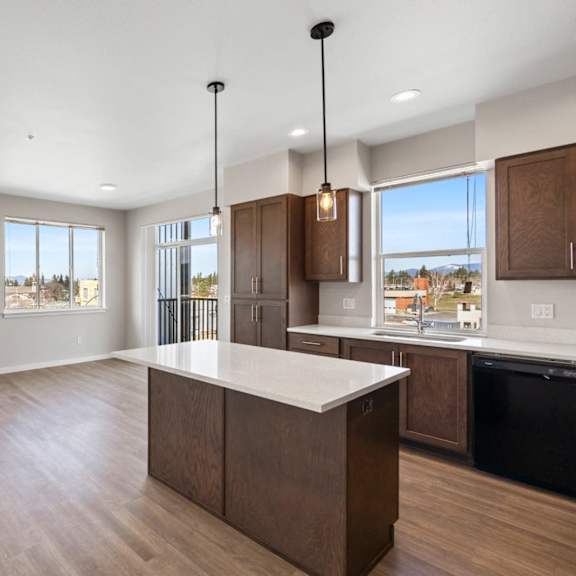 a kitchen with a large island and wooden cabinets.