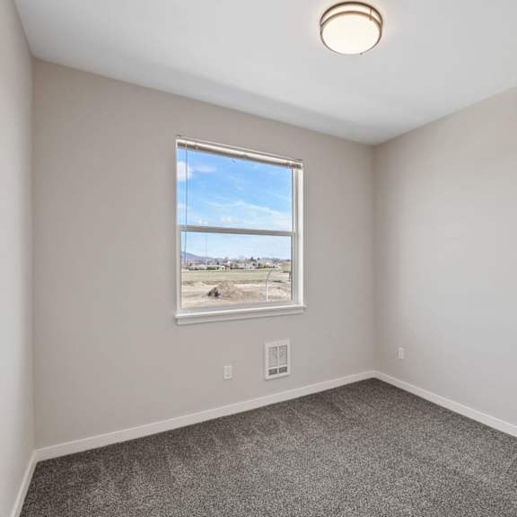 a room with a window showing a beach scene.