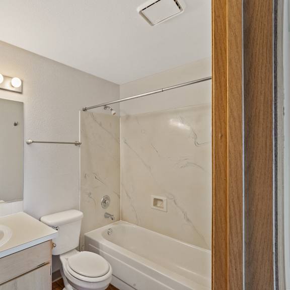 a bathroom with a sink and a tub and a shower