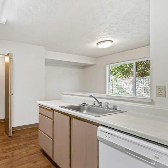 kitchen with white appliances and wood flooring
