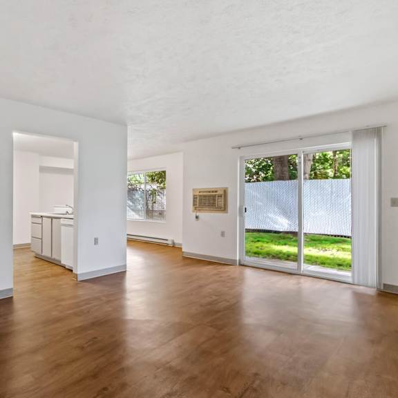 a room with wooden floors and white walls.