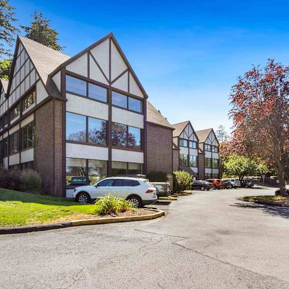a large building with cars parked in front of it