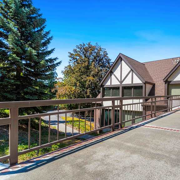 the front of a house with a deck and a driveway