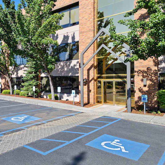a parking lot in front of a building with disabled parking spaces